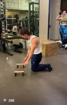 Male athlete doing full planche on thumbs