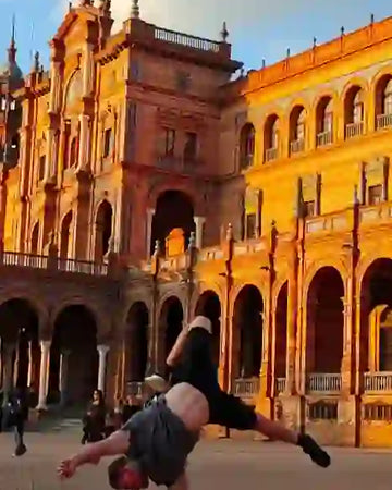 Calisthenics athlete doing one arm handstand on parallettes