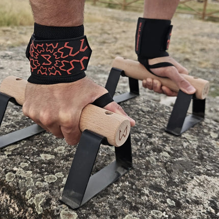 Person using parallettes wearing wrist wraps of wild dynamics