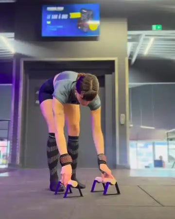 Female athlete using parallettes