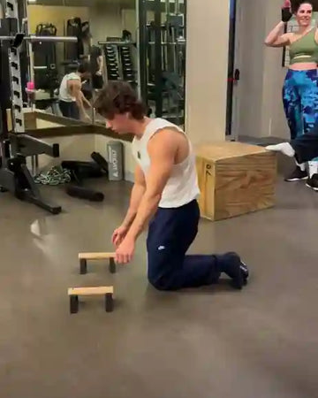 Male athlete doing full planche on thumbs