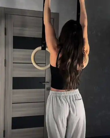 Female calisthenics athlete using rings