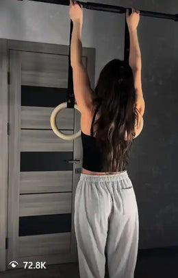 Female calisthenics athlete using rings