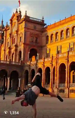 Calisthenics athlete doing one arm handstand on parallettes