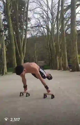 Calisthenics athlete doing planche on parallettes