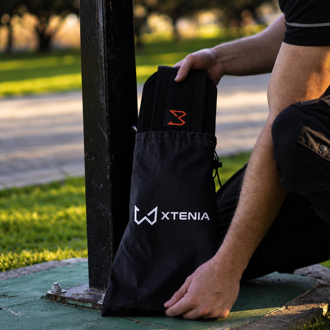 Dip belt with carry bag in outdoor calisthenics park